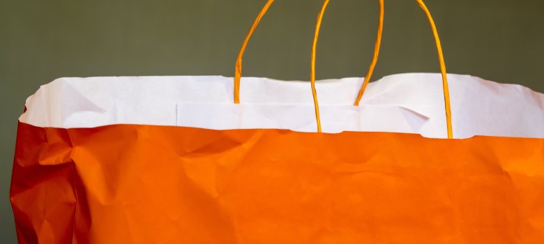 Auf dem Bild ist eine orangene Papiertüte zu sehen.
