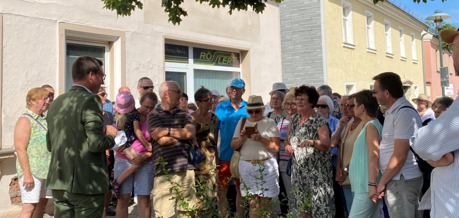 Auf dem Bild sind viele Menschen zu sehen. Zudem ist der Bürgermeister Michael Abraham zu sehen.