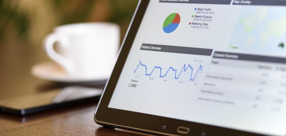 Auf dem Bild ist ein Tablet mit Statistiken und Grafiken zu sehen.