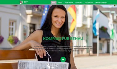 Die Grafik zeigt die Startseite der KOMPASS-Seite von Rehau. Im Hintergrund ist eine Frau mit einer Einkaufstasche auf einer Bank am Maxplatz sitzend zu erkennen.