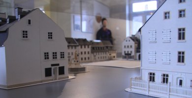 Das Bild zeigt ein Stadtmodell von Asch. Konkret wird der Ascher Marktplatz mit einem Brunnen abgebildet.